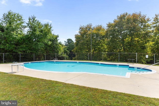 view of swimming pool with a lawn and a patio