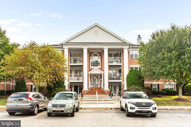 view of front of house featuring a balcony