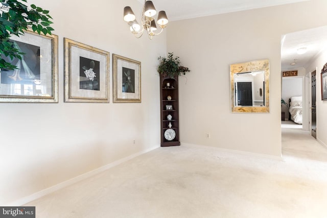 empty room with carpet flooring, ornamental molding, and an inviting chandelier