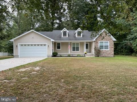 view of front of property featuring a garage and a front lawn