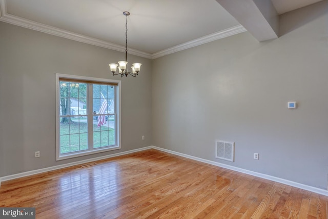 empty room with light hardwood / wood-style floors, ornamental molding, and a chandelier