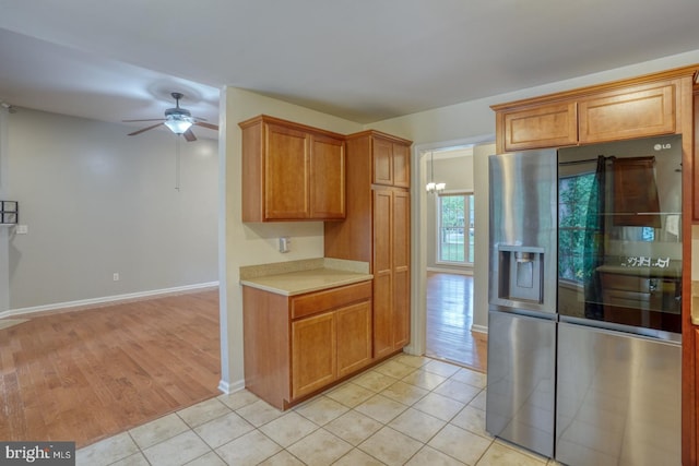 kitchen featuring light hardwood / wood-style flooring, stainless steel refrigerator with ice dispenser, and ceiling fan