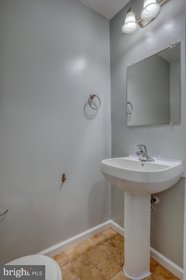 bathroom with sink, tile patterned flooring, and toilet