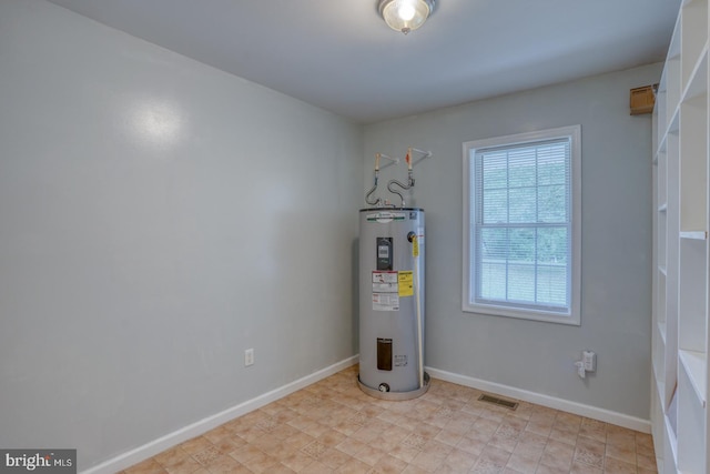 utility room featuring water heater