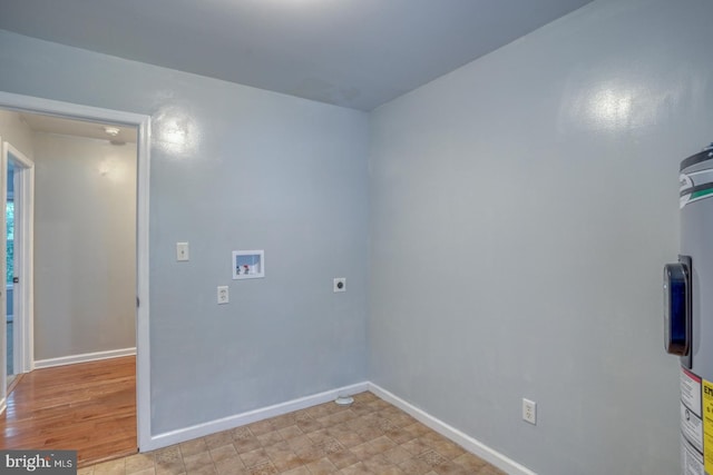 washroom with hookup for a washing machine, electric water heater, light wood-type flooring, and hookup for an electric dryer