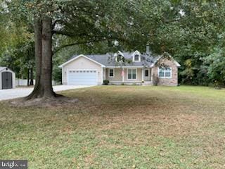 view of front facade with a front yard and a garage