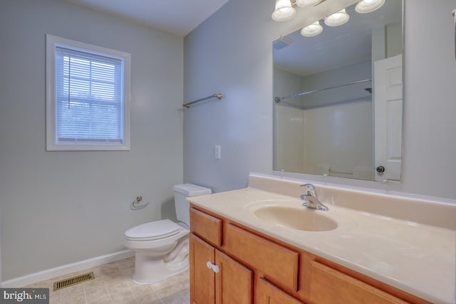 bathroom featuring a shower, vanity, and toilet