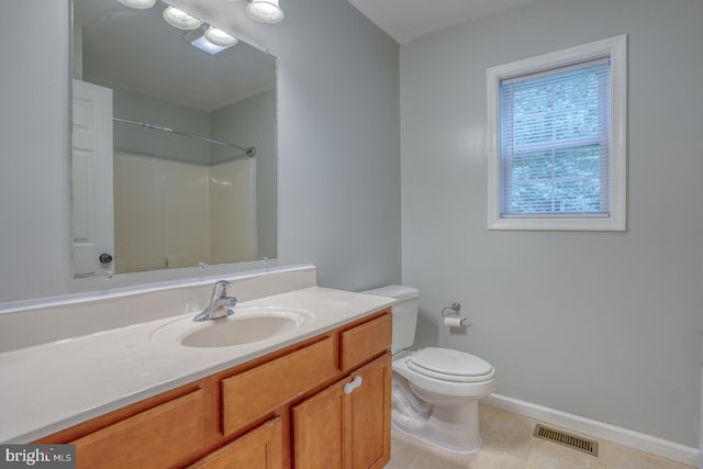 bathroom with a shower, tile patterned flooring, vanity, and toilet