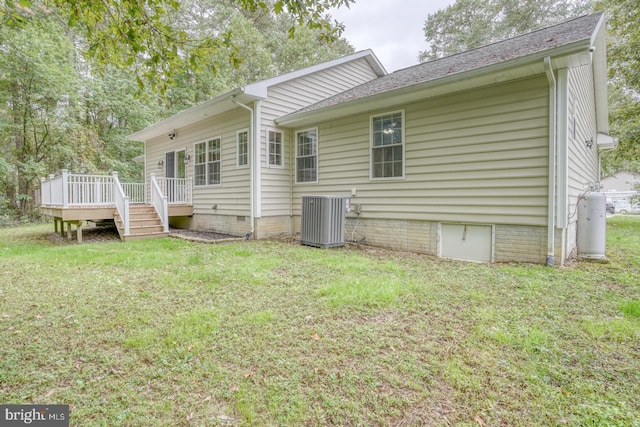 view of property exterior with cooling unit, a deck, and a yard