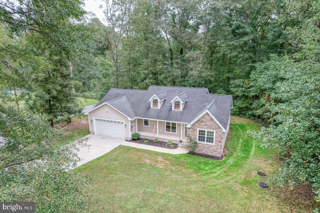 cape cod home with a front lawn and a garage