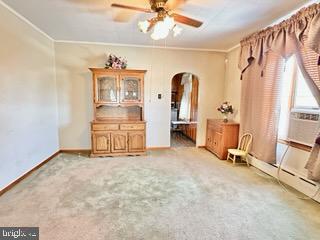 unfurnished room with crown molding, ceiling fan, and light colored carpet