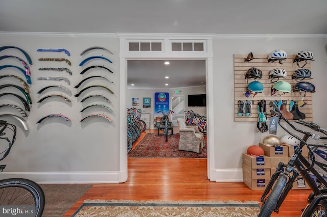 foyer entrance with light hardwood / wood-style floors and crown molding