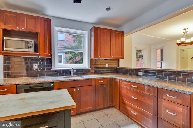 kitchen featuring decorative backsplash, dishwasher, sink, light tile patterned floors, and light stone counters