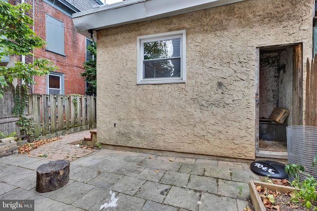 view of side of home with a patio area