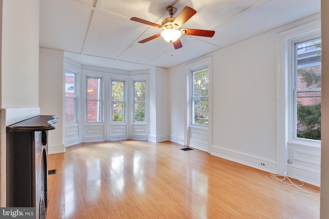 unfurnished living room with ceiling fan and light hardwood / wood-style flooring