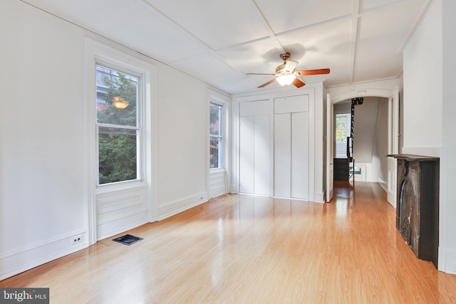 unfurnished living room with light hardwood / wood-style flooring, a wealth of natural light, and ceiling fan