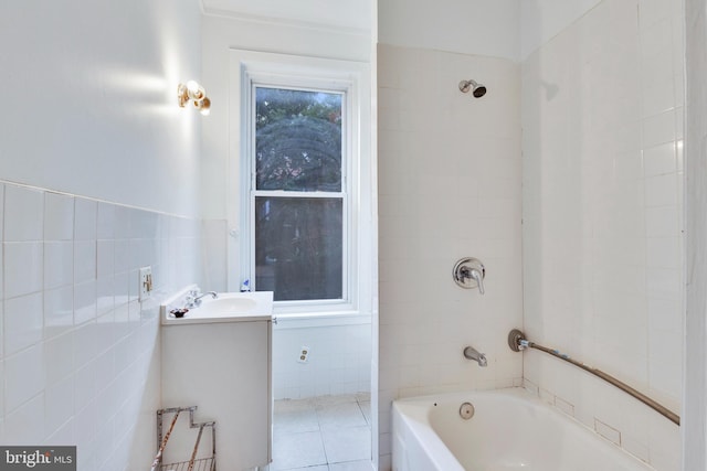 bathroom featuring vanity, tile walls, tiled shower / bath, and tile patterned flooring