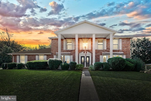 neoclassical home with a lawn