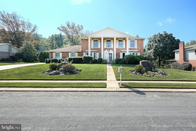 greek revival inspired property with a front lawn