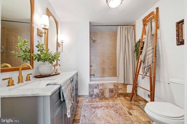 full bathroom featuring vanity, shower / tub combo, and toilet