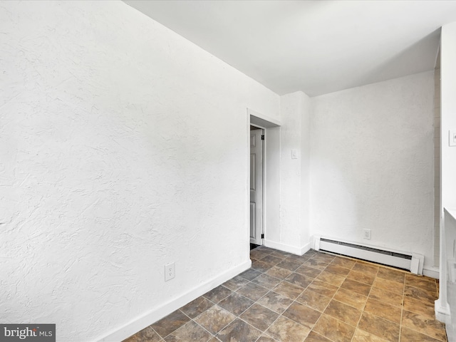 empty room with a baseboard heating unit