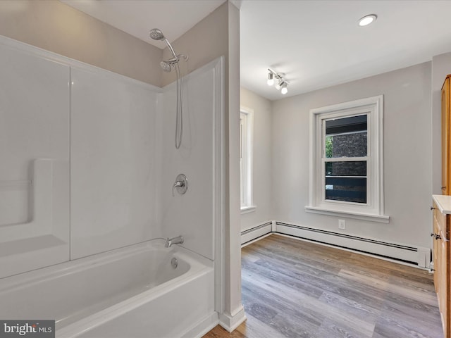 bathroom featuring a baseboard radiator, shower / tub combination, wood-type flooring, and vanity