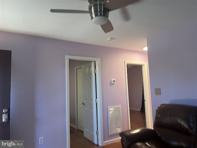 sitting room featuring dark hardwood / wood-style floors and ceiling fan