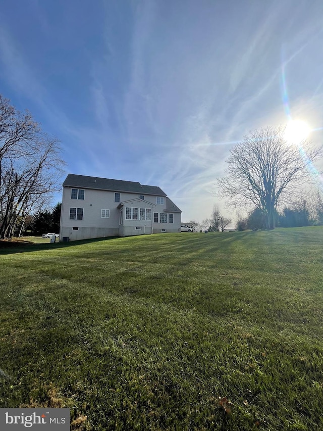 back of property with a lawn