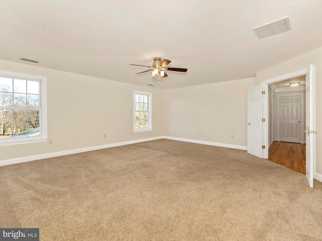 spare room with carpet flooring and ceiling fan