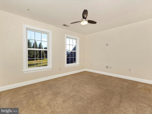 carpeted empty room featuring ceiling fan