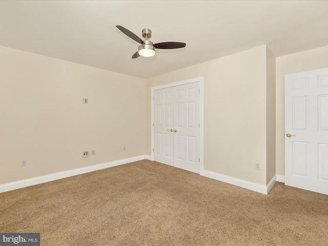 interior space with carpet flooring and ceiling fan