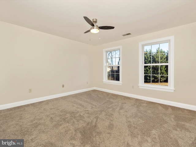 unfurnished room with ceiling fan and carpet floors