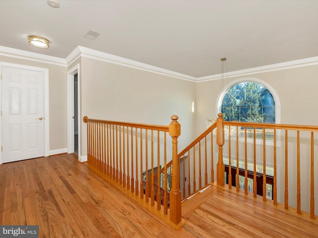 stairway featuring hardwood / wood-style flooring and ornamental molding