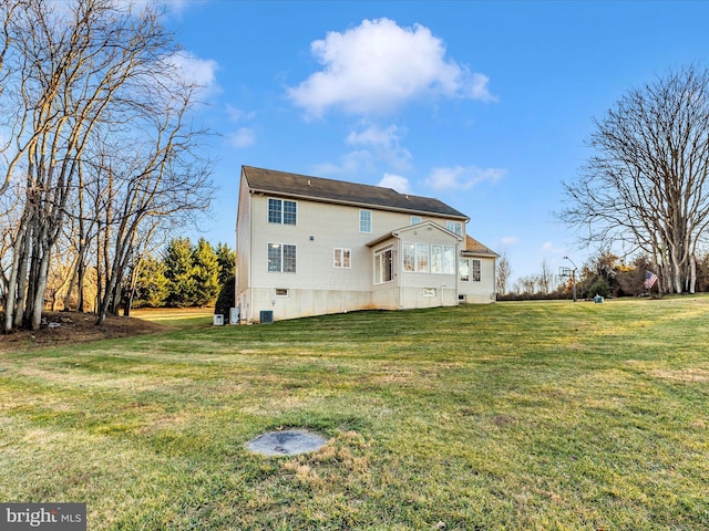 rear view of property with a yard