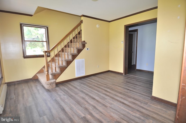 unfurnished room featuring ornamental molding and wood-type flooring