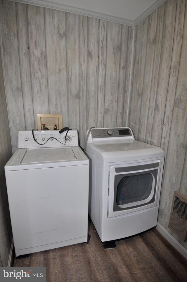 clothes washing area featuring independent washer and dryer and dark wood-type flooring