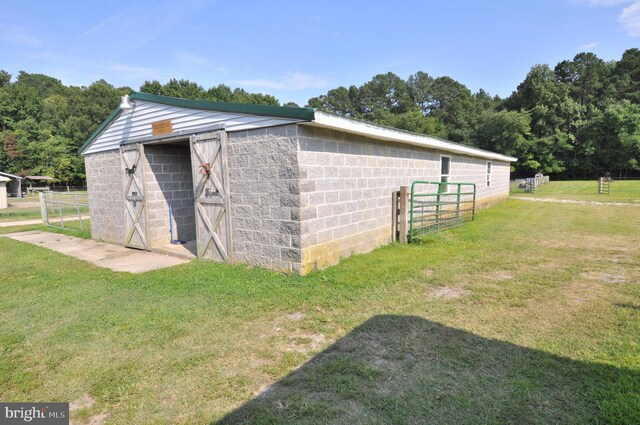 view of outbuilding featuring a lawn