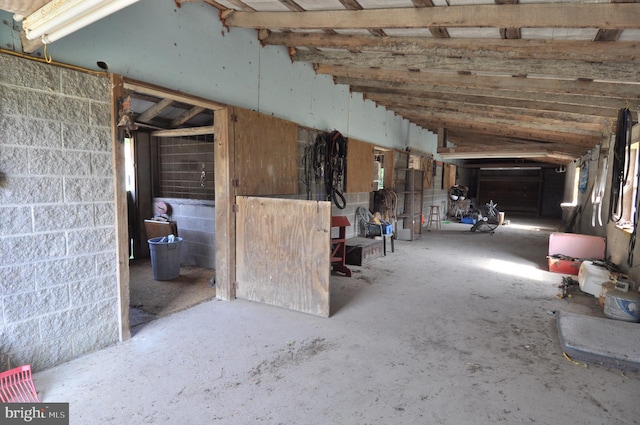 misc room with concrete flooring and vaulted ceiling