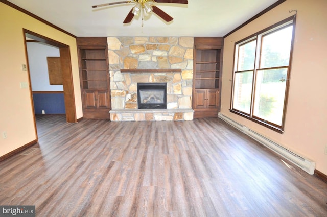 unfurnished living room featuring ceiling fan, ornamental molding, a stone fireplace, a baseboard radiator, and hardwood / wood-style floors