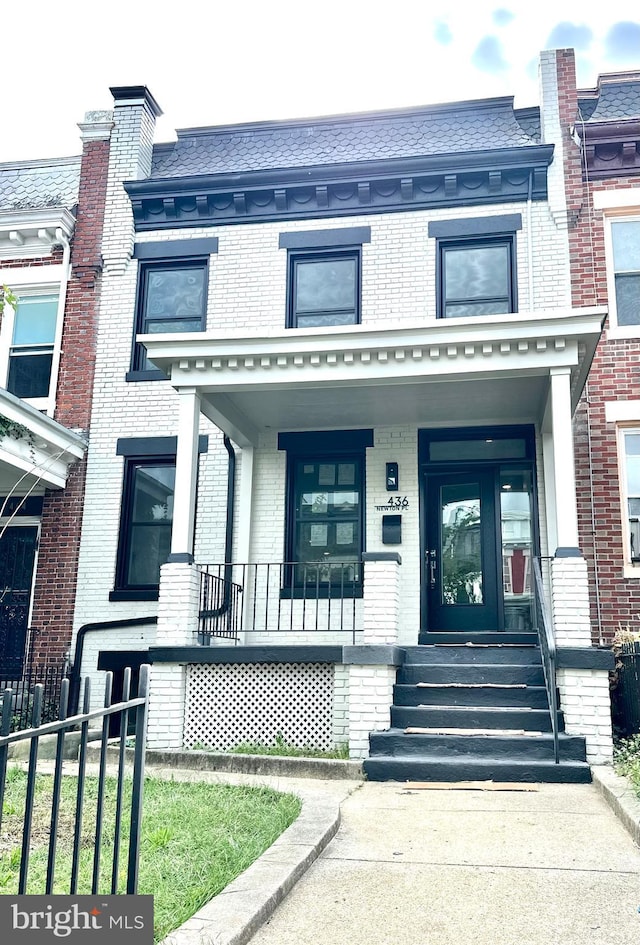 townhome / multi-family property featuring a porch