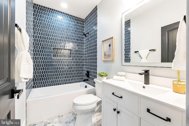 full bathroom with vanity, tiled shower / bath combo, and toilet