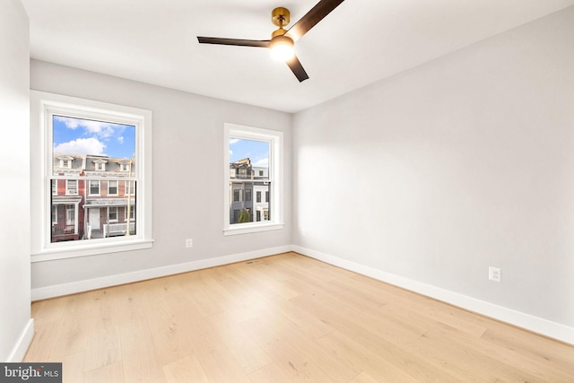 empty room featuring ceiling fan and light hardwood / wood-style flooring