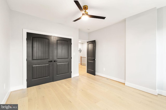 unfurnished bedroom featuring ceiling fan, a closet, and light hardwood / wood-style floors