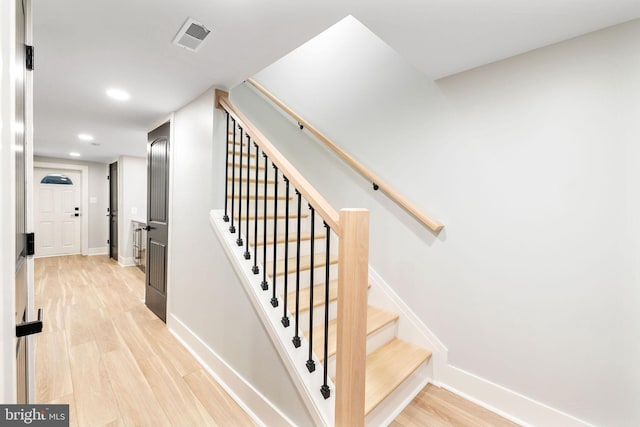 staircase featuring hardwood / wood-style flooring