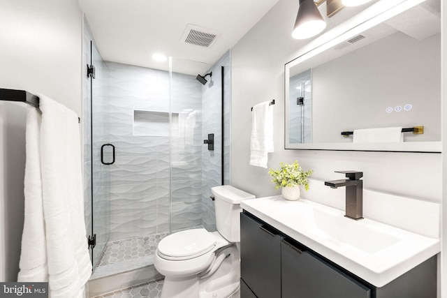 bathroom featuring an enclosed shower, tile patterned floors, vanity, and toilet