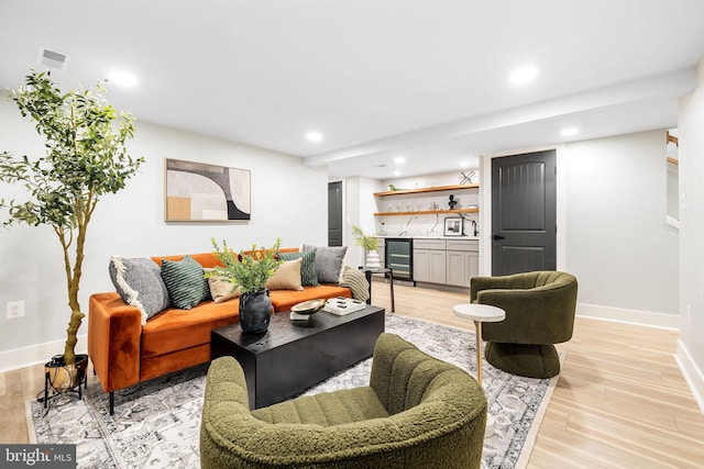 living room featuring light wood-type flooring and beverage cooler