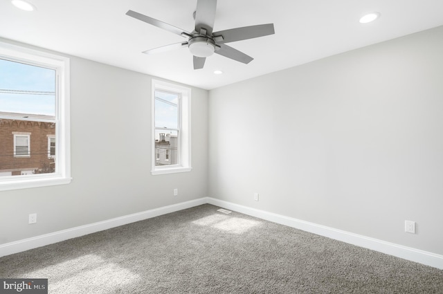 carpeted empty room featuring ceiling fan