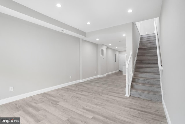 stairway with hardwood / wood-style flooring