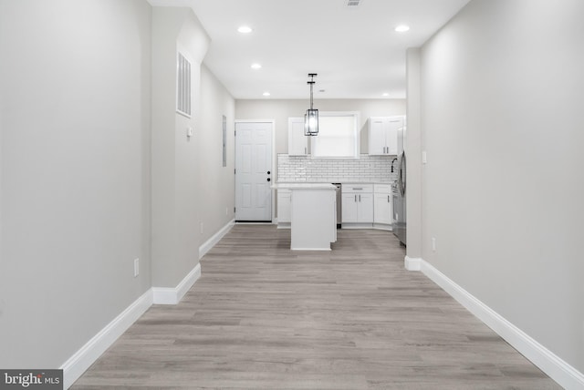 hallway with light hardwood / wood-style flooring