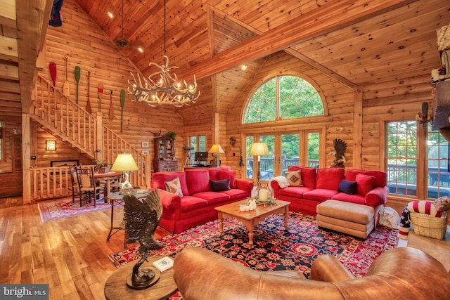 living room with wood ceiling, hardwood / wood-style floors, high vaulted ceiling, and a chandelier